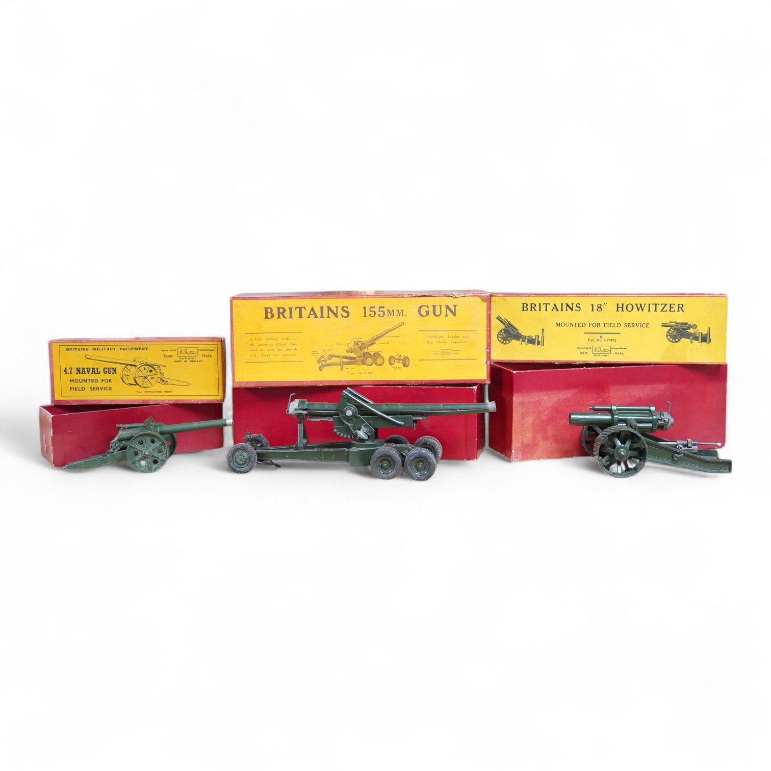 Three boxed Britains military field guns; a 4.7” Naval Gun, mounted for field service (No.1264), an 18” Howitzer (No.2107), and a 155mm Gun (No.2064), all with some accessories and shells missing